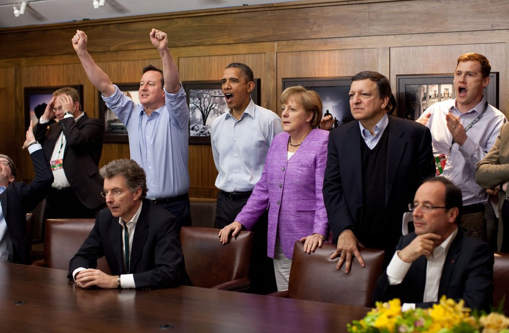 Prime Minister David Cameron of the United Kingdom, President Barack Obama, Chancellor Angela Merkel of Germany, Jos Manuel Barroso, President of the European Commission, and others watch the overtime shootout of the Chelsea vs. Bayern Munich Champions League final in the Laurel Cabin conference room during the G8 Summit at Camp David, Md., May 19, 2012. (Official White House Photo by Pete Souza) This official White House photograph is being made available only for publication by news organizations and/or for personal use printing by the subject(s) of the photograph. The photograph may not be manipulated in any way and may not be used in commercial or political materials, advertisements, emails, products, promotions that in any way suggests approval or endorsement of the President, the First Family, or the White House.